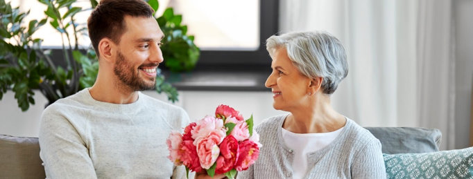 son giving flowers to his mother