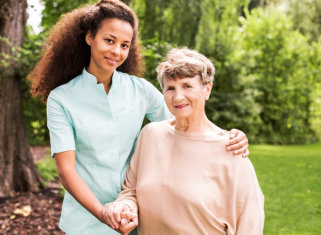 caregiver and senior woman outdoors