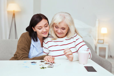 caregiver and senior woman playing with blocks