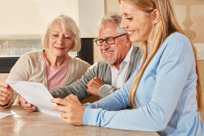 happy senior couple with their caregiver