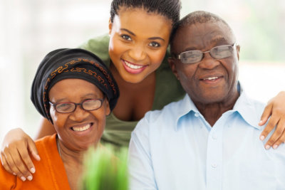 happy senior couple with caregiver