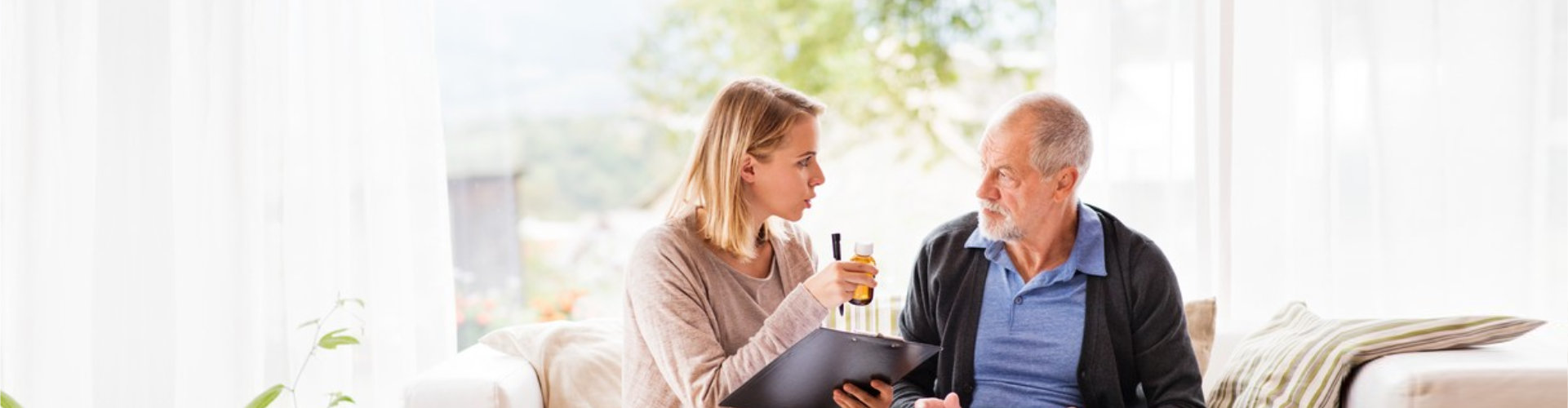 caregiver reminding senior with his medicine