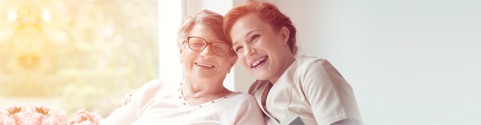 smiling caregiver and senior woman