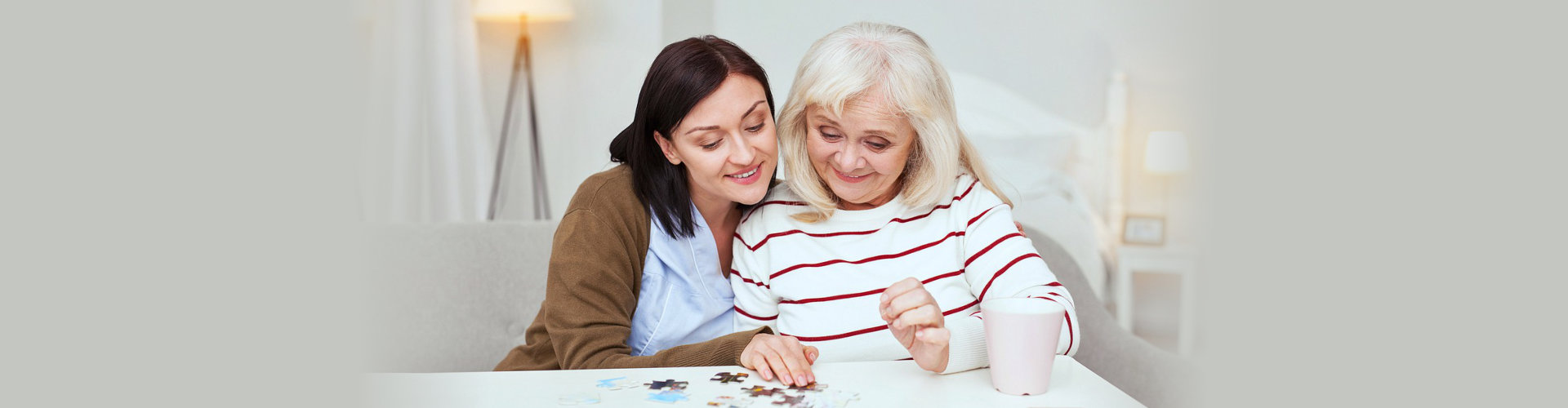 caregiver and senior woman playing with blocks