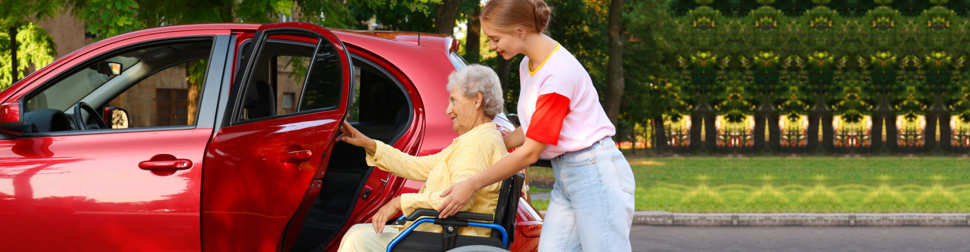 woman helping a senior woman get into the car