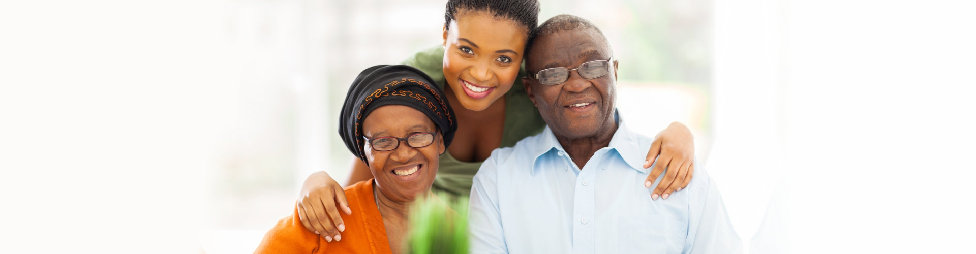 happy senior couple with caregiver