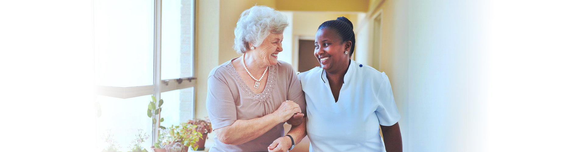 caregiver and senior woman walking outdoors