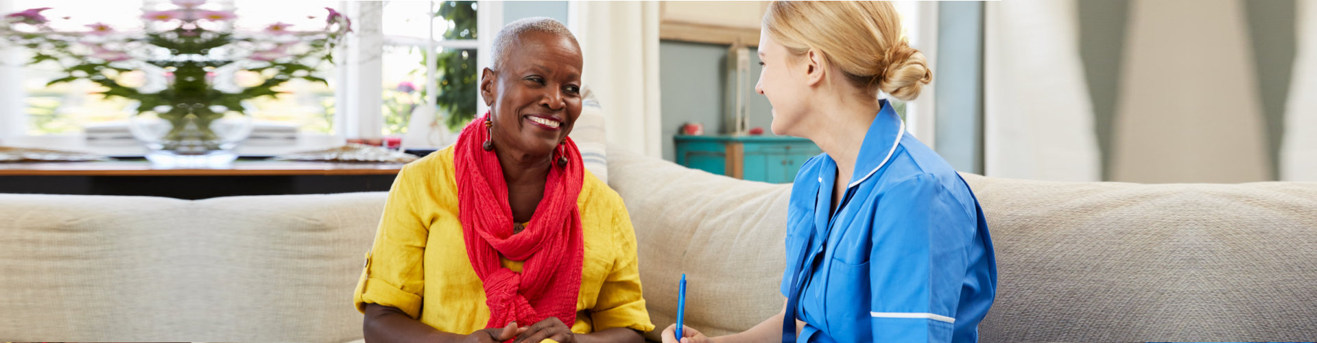 caregiver talking to a senior woman